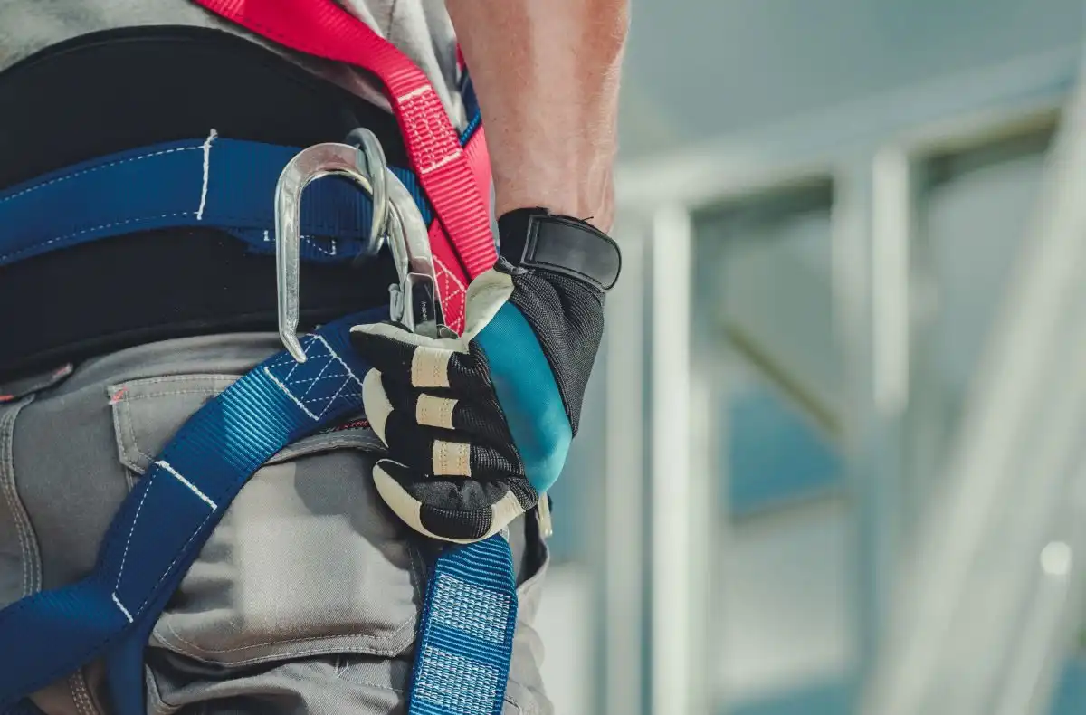 Safety karabiner on a harness, on a structure with a glass roof
